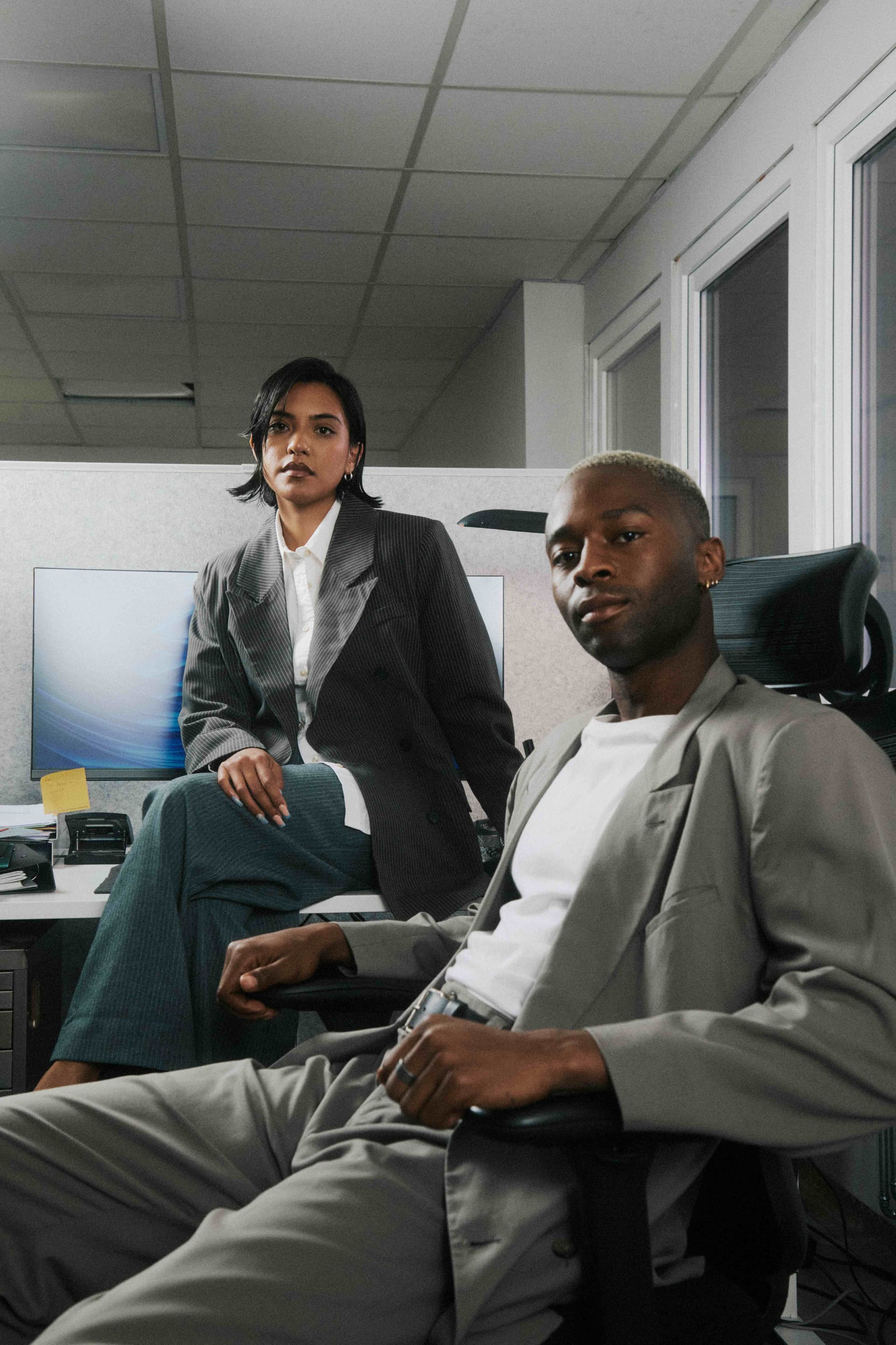 Two colleagues posing confidently to camera.
